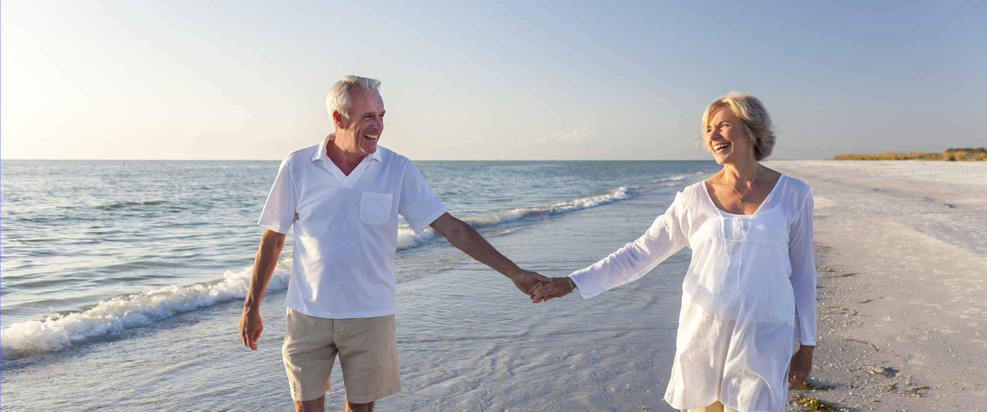 Happy couple walking on the beach
